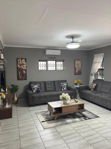 a living room with a couch and a coffee table at Inyati Guest House in Marloth Park
