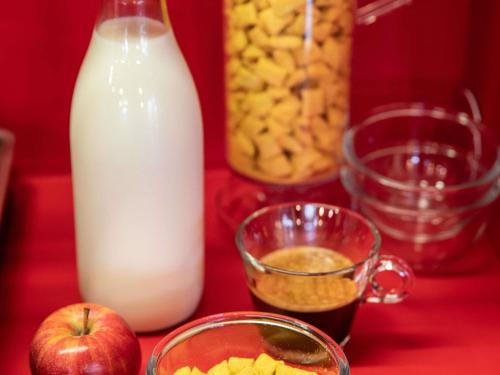 a table with a bottle of milk and an apple at hotelF1 Paris Porte de Montreuil in Bagnolet