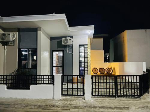 a small house with a black fence at JMS Suite Cabanatuan in Bangad