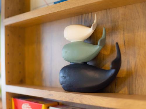 a figurine of a whale sitting on a shelf at ibis budget Besançon Centre Gare in Besançon