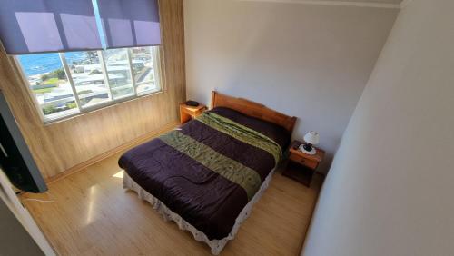 a bedroom with a bed in a room with a window at Vacaciones frente al Mar in Valparaíso