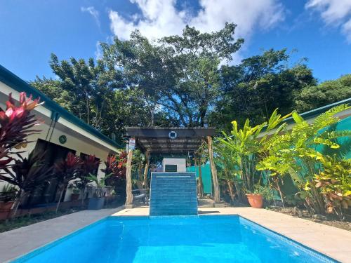 a swimming pool in front of a house at Casa Uvita Bay in Uvita