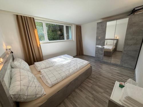 a bedroom with two beds and a glass shower at AIRR Wohnung in Flumenthal in Flumenthal