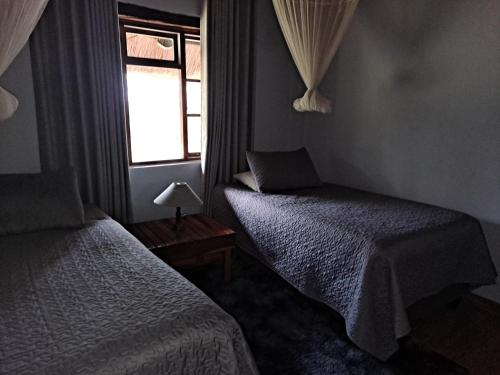 Llit o llits en una habitació de Kweza Cottages