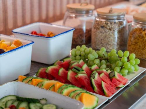 a table topped with plates of fruit and other foods at ibis budget Marne la Vallée Val d'Europe in Montévrain