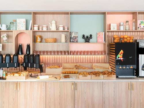 a bakery counter with many different types of pastries at ibis budget Marne la Vallée Val d'Europe in Montévrain