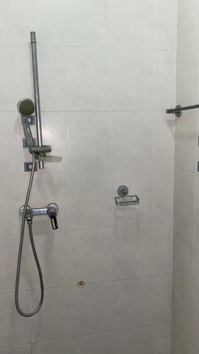 a shower in a bathroom with a shower head at mermoz Dakar in Dakar
