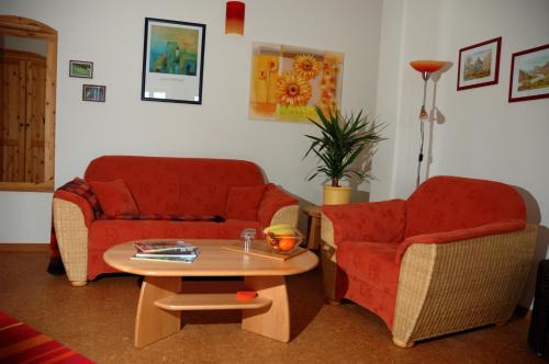 a living room with two chairs and a coffee table at Ökopension Villa Weissig in Struppen