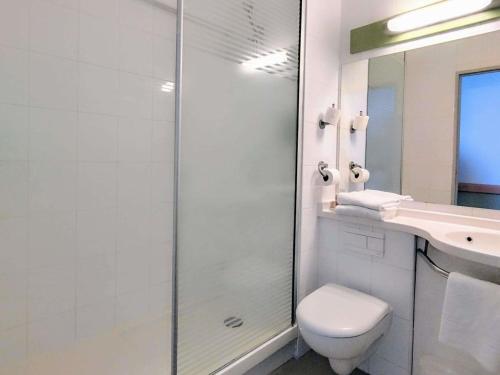 a bathroom with a toilet and a sink and a shower at Ibis Budget Toulon Centre in Toulon
