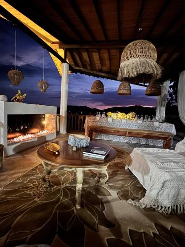 a room with a bed and a table and a fireplace at Casablanca Hotel Boutique Salamina in Salamina