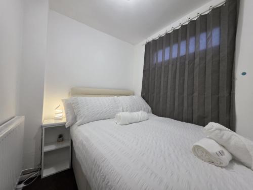 a bedroom with a bed with two towels on it at Cozy Birmingham city center home with free parking in Birmingham