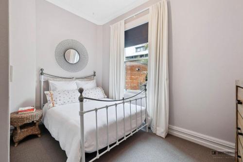 a bedroom with a bed and a window at Villa on Rattray in Dunedin