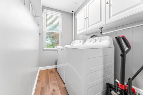 a white laundry room with a washer and dryer at Main Floor Tremont Home with KING Bed, Mins From DT, Pet Friendly in Cleveland