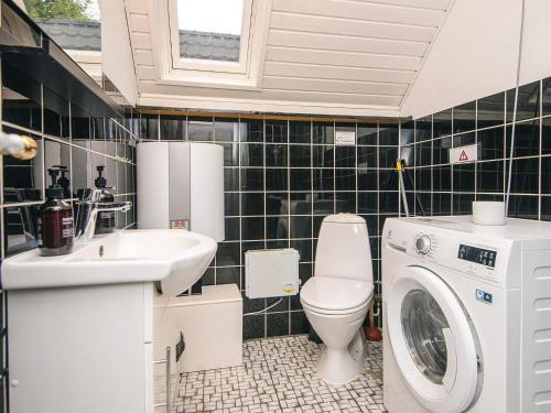 a bathroom with a washing machine and a washer at 6 person holiday home in Herning in Herning