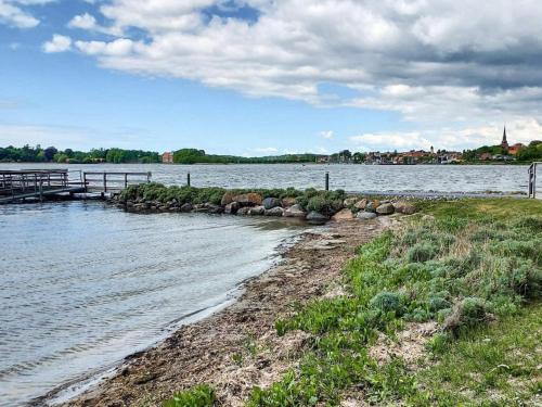 a river with a dock in the middle of it at Seaside Bliss in Nysted - By Traum Ferienwohnungen in Nysted
