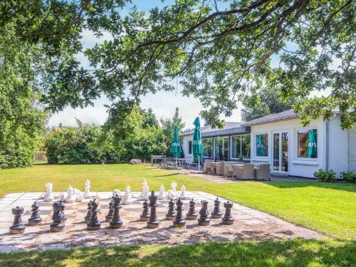 a giant chessboard on a patio in front of a house at Aabenraa Camping in Aabenraa