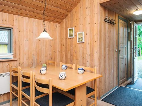 a wooden dining room with a wooden table and chairs at 6 person holiday home in Hovborg in Hovborg