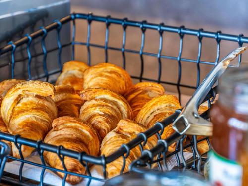 a bunch of pastries are sitting in a basket at ibis budget La Roche Sur Yon Vendespace in Mouilleron-le-Captif