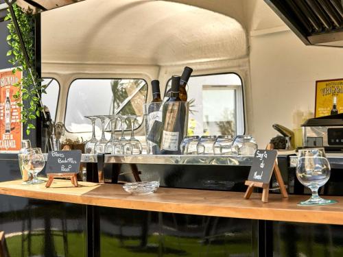 a table with glasses and a bottle of wine at ibis budget La Roche Sur Yon Vendespace in Mouilleron-le-Captif