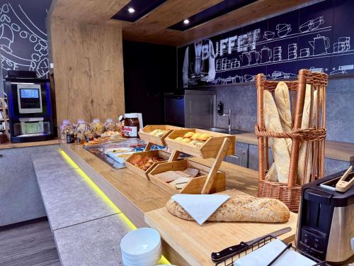 a kitchen with a counter with bread on it at Ibis Budget Marseille Vitrolles in Vitrolles