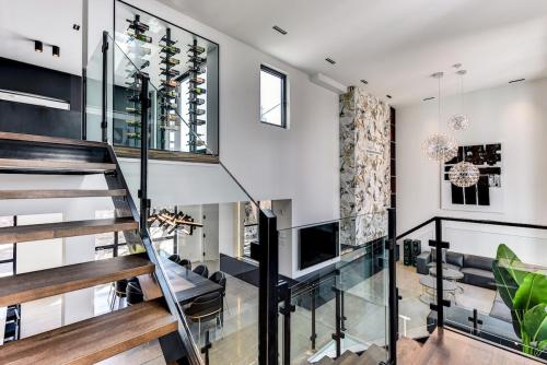 a glass staircase in a home with a living room at CLUBHAUS Hotel in Montréal