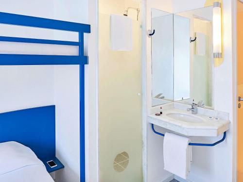 a bathroom with a sink and a bunk bed at ibis budget Curitiba Centro in Curitiba