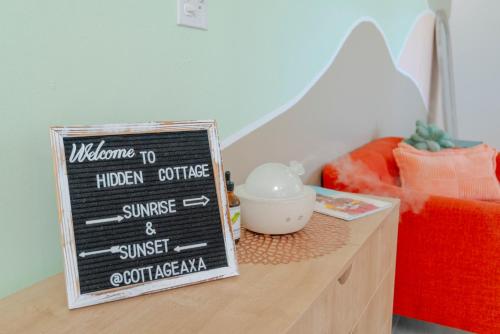 a chalkboard sign sitting on top of a counter at The Hidden Cottage in Welches Hill