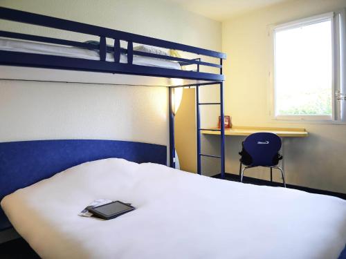 a bedroom with a bed and a bunk bed at ibis budget Meung sur Loire in Meung-sur-Loire