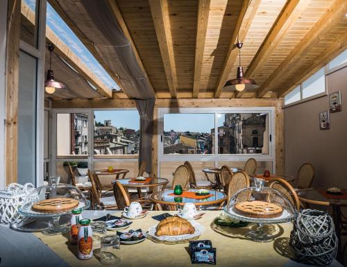 a dining room with a table with food on it at Ariston Suite in Piazza Armerina