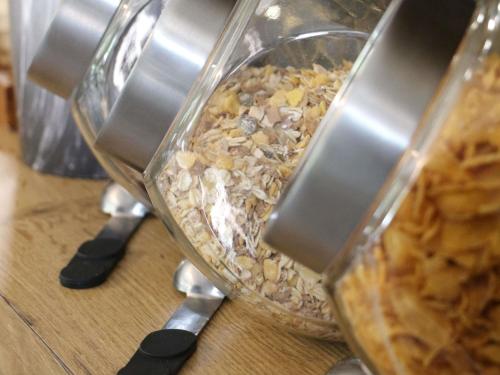 a glass container filled with food on top of a counter at Ibis Budget Agen in Le Passage