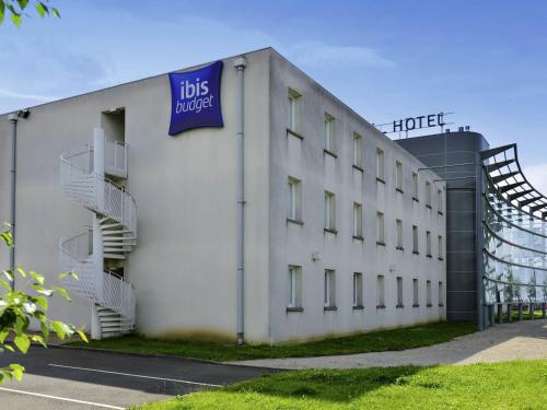 a white building with a sign on the side of it at Ibis budget Orléans Sud Comet in Orléans