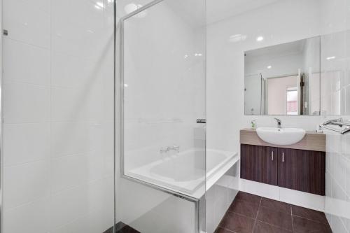 a bathroom with a glass shower and a sink at Wroxton Street in Bellevue