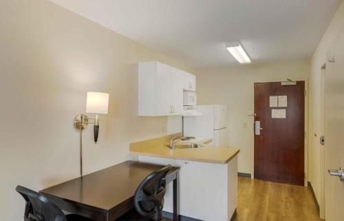 a small kitchen with a table and a sink at Extended Stay America Suites - New York City - LaGuardia Airport in Queens