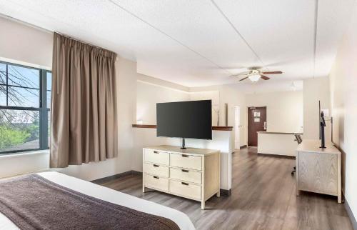 a bedroom with a bed and a flat screen tv at Extended Stay America Suites - Long Island - Melville in Melville