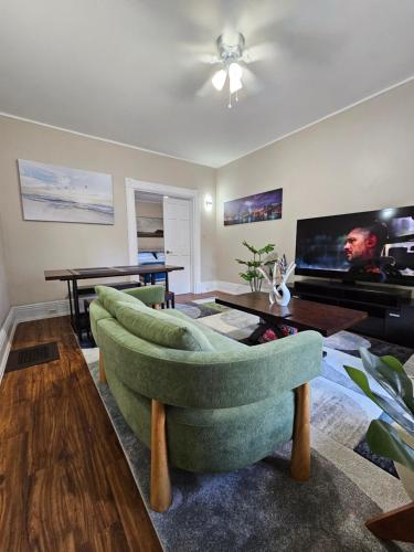 a living room with a couch and a tv at King Comfort Retreat in Peterborough