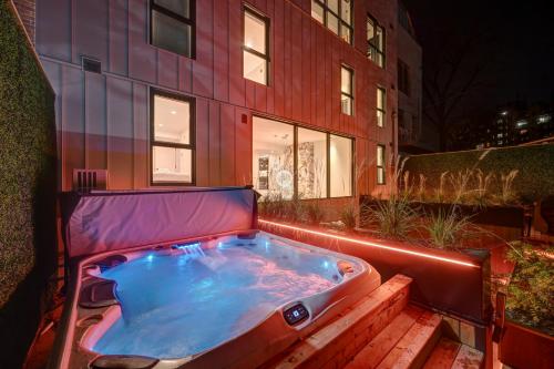 a hot tub sitting in front of a building at CLUBHAUS Hotel in Montréal