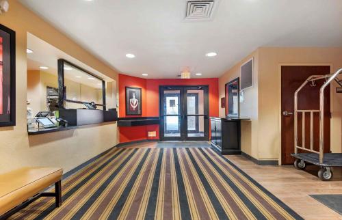 a large room with orange walls and a hallway at Extended Stay America Suites - Pittsburgh - Monroeville in Monroeville