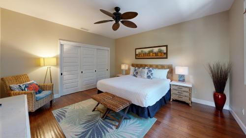 a bedroom with a bed and a ceiling fan at HAWAIIAN JEWEL Family friendly KaMilo 4BR Home Walk to Pauoa Beach in Waikoloa