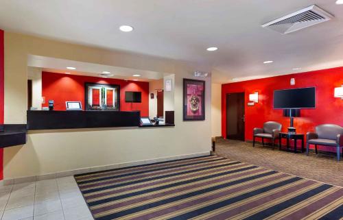 a lobby with a waiting room with red walls at Extended Stay America Suites - Baltimore - Glen Burnie in Glen Burnie