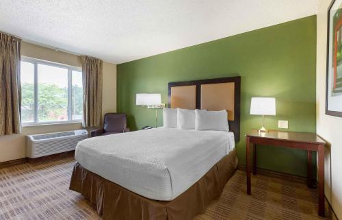 a hotel room with a large bed and a window at Extended Stay America Suites - Baltimore - Glen Burnie in Glen Burnie