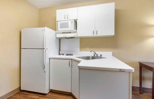 a kitchen with a white refrigerator and a sink at Extended Stay America Suites - Baltimore - Glen Burnie in Glen Burnie