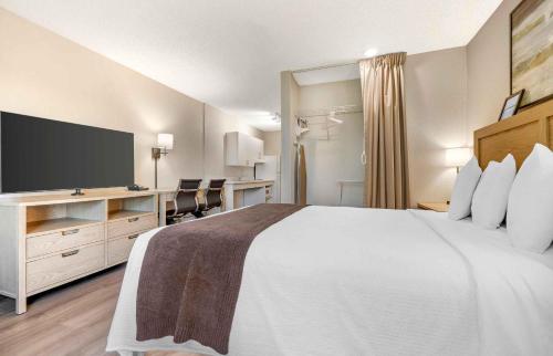 a hotel room with a large bed and a desk at Extended Stay America Suites - San Diego - Carlsbad Village by the Sea in Carlsbad