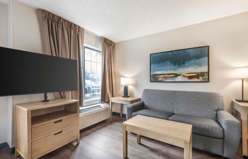 a living room with a couch and a flat screen tv at Extended Stay America Suites - San Diego - Carlsbad Village by the Sea in Carlsbad