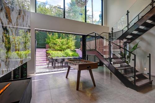 a glass staircase in a house with a table at CLUBHAUS Hotel in Montréal