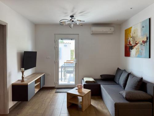 a living room with a couch and a tv at Apartment Mani in Koper
