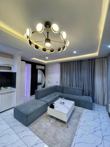 a living room with a couch and a table at Emiola mews apartments in Lekki