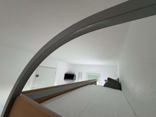 a staircase in a house with a white wall at Ibis Budget Ancenis in Mésanger