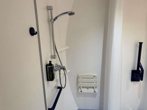 a shower stall in a bathroom with at Ibis Budget Ancenis in Mésanger