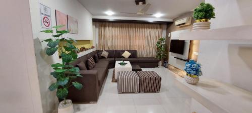 a living room with a couch and a table at Spacious 2BR Portion with Rooftop Gulshan e Iqbal Block 7 in Karachi