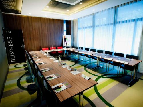a large conference room with long tables and chairs at ibis budget Brest Centre Port in Brest